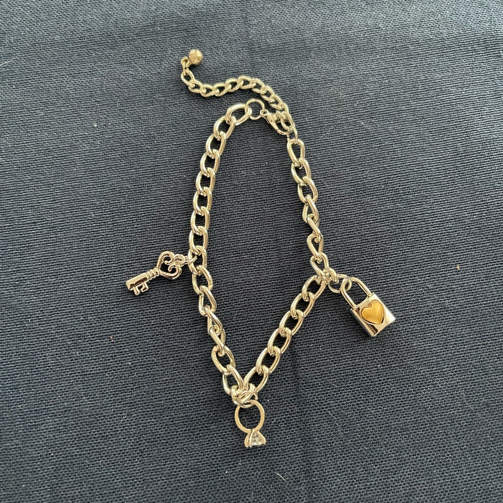 Silvertone charm bracelet with 3 charms.  Love theme